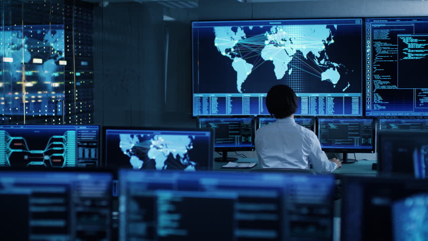 In the System Control Room Chief Operator Watches Screens With Satellite Data. Monitoring Station Has Capacity for Global Data and Monitoring, Every Interaction is Shown in Real Time on Displays Royalty-Free Stock Footage #1024872185