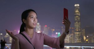 Woman talk to cellphone in city at night