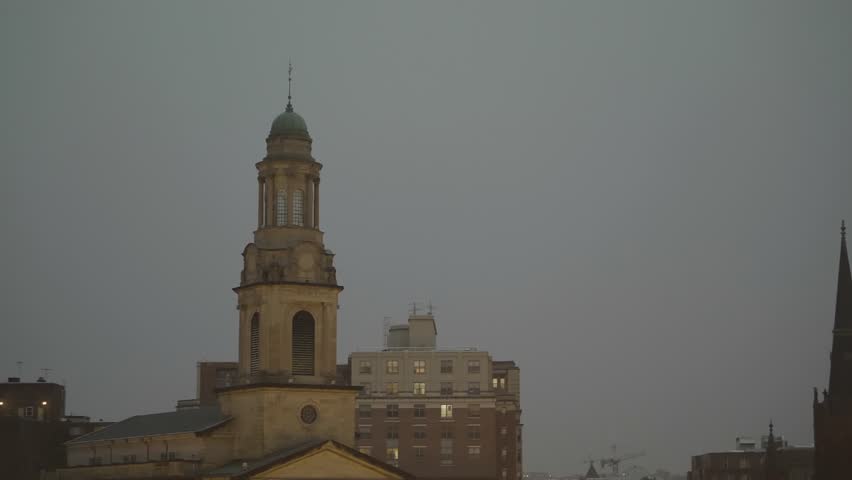 Snow fall with the bell tower of the National City Church in the background