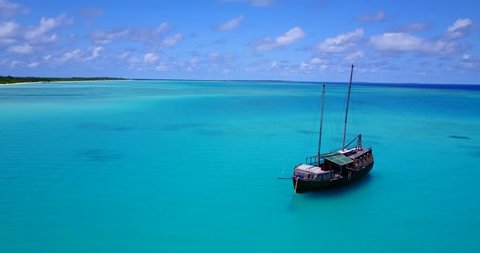 Old fashioned wooden boat resting on beautiful azure waters in the Maldives 4k