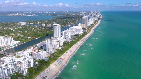 MIAMI, FLORIDA, USA - JANUARY 2019: Aerial drone panorama view flight over South Miami and Mid-Beach ocean coastline. Miami Beach Boardwalk from above at sunny day.