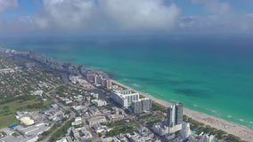 MIAMI, FLORIDA, USA - JANUARY 2019: Aerial drone panorama view flight over South Miami and Mid-Beach ocean coastline. Miami Beach Boardwalk from above at sunny day.
