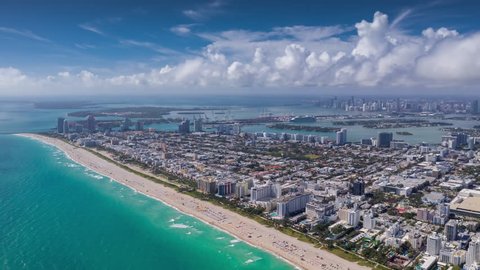 MIAMI, FLORIDA, USA - JANUARY 2019: Aerial hyperlapse 4k drone panorama view flight over South Miami and Mid-Beach ocean coastline. Miami Beach Boardwalk from above at sunny day.