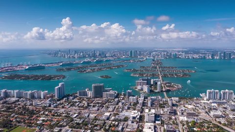 MIAMI, FLORIDA, USA - JANUARY 2019: Aerial drone panorama view flight over Miami Beach city centre. Venetian Islands and Biscayne Bay. Streets, hotels and residential buildings from above.