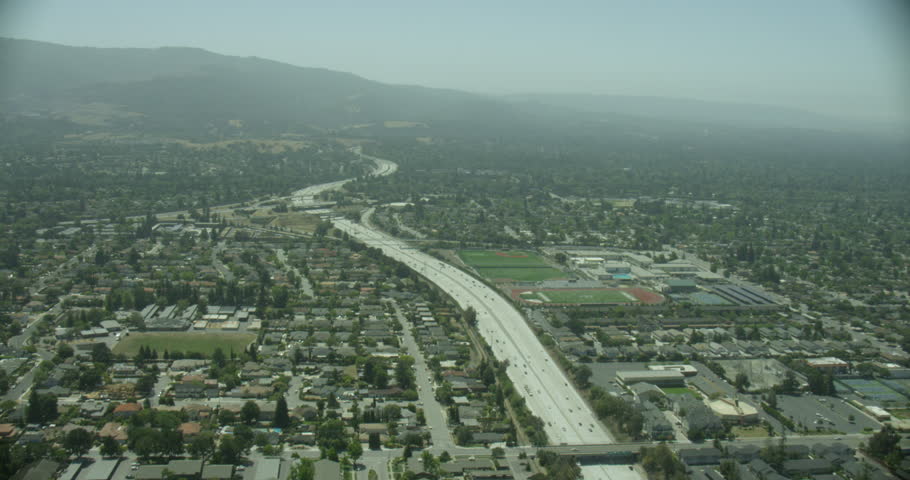 Camera panning over highway, helicopter aerial, day