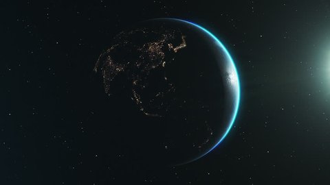 Looping animation of the night side of earth, slowly rotating in space. The sun backlights the planet, revealing a million lights from cities on the surface below. Clip loops seamlessly.