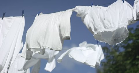 Laundry flapping on a clothesline ouside on a summer day