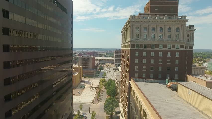 Tilt down aerial view over a city street of Tulsa, Oklahoma and the high-rise buildings on a clear sunny day.