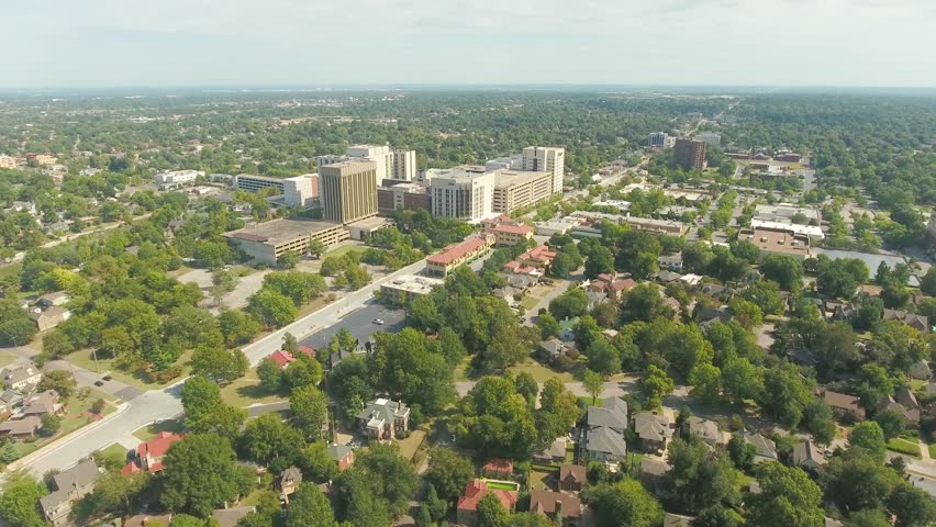 Wide panoramic aerial of the city of Tulsa, Oklahoma and surrounding residential suburbs, on a sunny day.