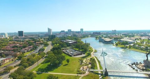 Wide panoramic aerial view over the Wichita landscape and flowing Arkansas River, Kansas on a sunny day.