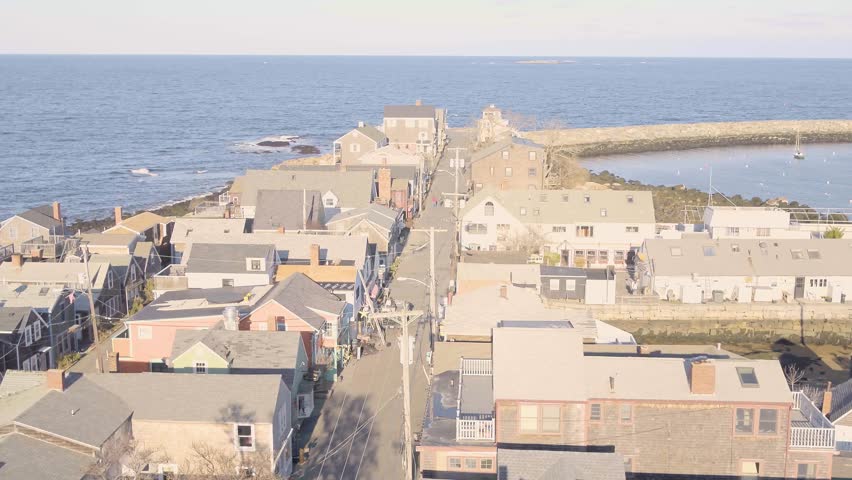 Aerial view of the light colored seaside village buildings of Rockport Massachusetts and the Atlantic Ocean.