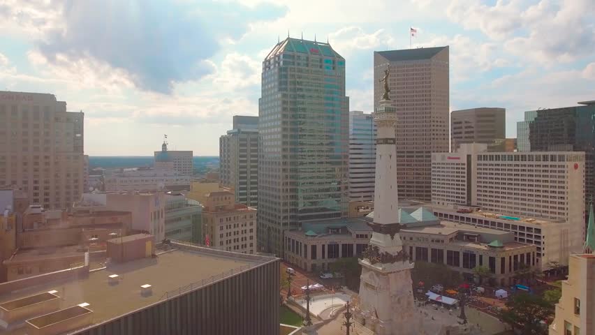 Aerial view moving towards the Indiana War Memorial - Soldiers - Sailors Monument among high-rise buildings, Indianapolis.
