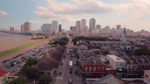 Aerial view of the New Orleans skyline, streets, architecture and the Mississippi River in the late afternoon.