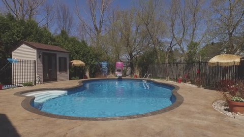 ritzy swimming pool in backyard dolly approach smoothly