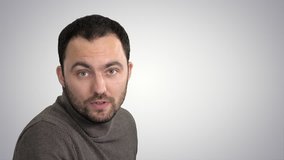 Man talking to camera on gradient background.