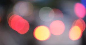 Defocused, blurred bokeh and abstract blurred light of car on street . Royalty high-quality free stock video footage of traffic light, glowing backdrop overlay for design. Traffic light in city night