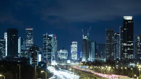 Tel Aviv Skyline and Ayalon Freeway Time lapse At Night Time - Tilt Down, Toned In Blue Color, Israel