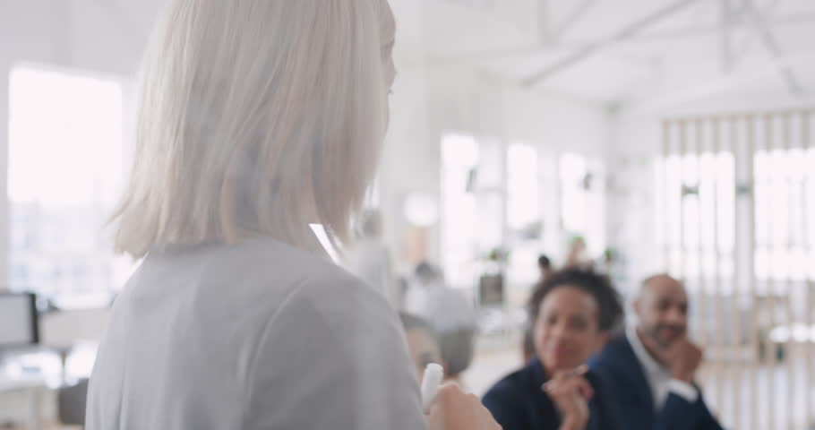 asian business woman team leader writing on glass whiteboard training colleagues sharing problem solving ideas in corporate seminar presentation Royalty-Free Stock Footage #1024966463