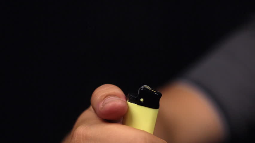 Close-up, of a man trying to light a gas lighter.