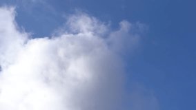 Beautiful cloudscape background. Timelapse of white clouds moving in blue sunny sky. Full hd video footage.