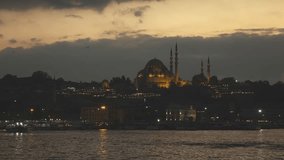 Night view of Eminonu Harbor, Beyoglu district historic architecture and Muslim Mosque in Istanbul Turkey on a nightfall sky. 4K UHD video, 3840, 2160p.