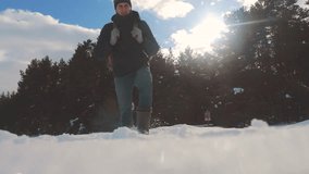 human feet go in deep snow winter. slow motion video. man traveler with backpack walks in the snow forest winter lifestyle. overcoming difficulties concept problems difficult path to success concept