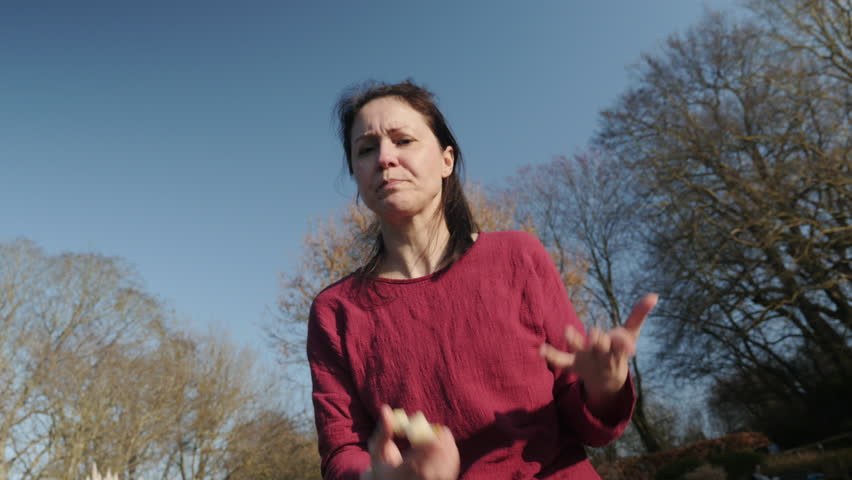 Happy Woman  eating fruit in The Park,Chatting to a friend. Woman enjoying the sun and feeling the freedom. 4K