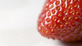 One strawberry close up footage on a white background.