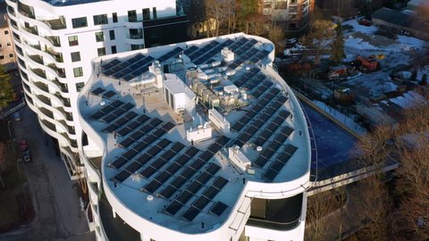 Luxurious apartment building with solar panels on top. Green energy building