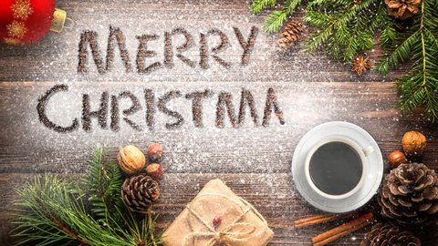 Merry Christmas Desk Animated Message 4K features a wooden surface with Christmas objects and snow and a hand-written Merry Christmas message appearing in the snow.