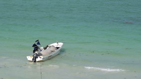 Small Fishing Boat Rocking on Shore at the Caribbean Sea Holbox Island at Mexico