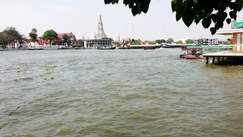 Riverside with boat and bangkok city background 4k video.Relaxtion summer cityscape with river Thailand