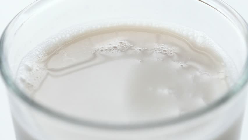 Milk close-up dripping splash. Glass of milk for breakfast | Shutterstock HD Video #1025000624
