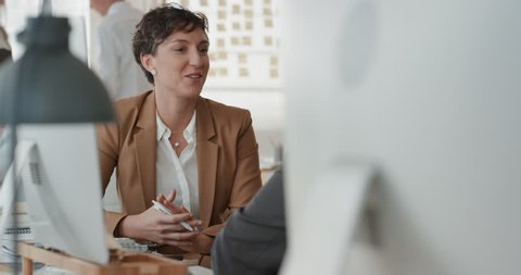 young business woman chatting to intern discussing job interview colleagues having conversation in office enjoying teamwork
