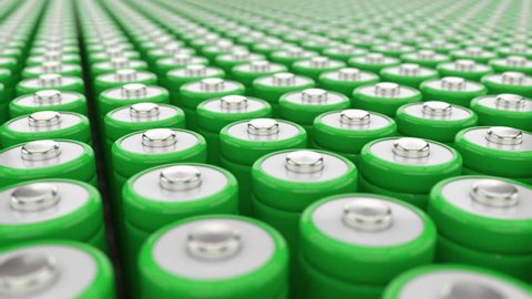 Electricity storage concept. Big field of green AAA batteries. Green energy concept