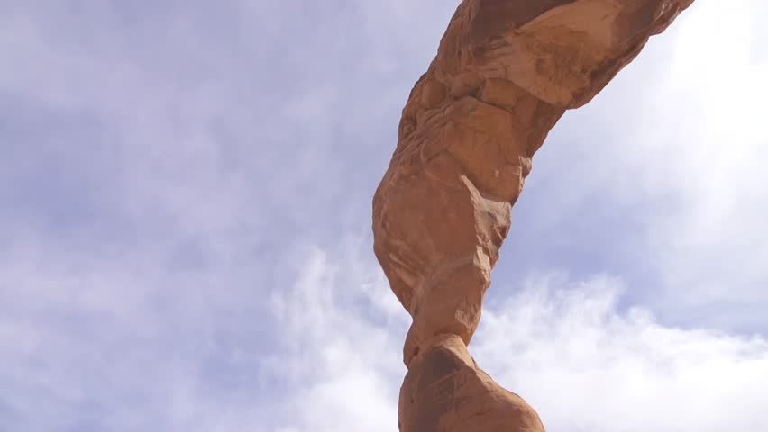 Man does crazy parkour wall flip off of natural stone sculpture in Arches National Park. Shot in slow motion
