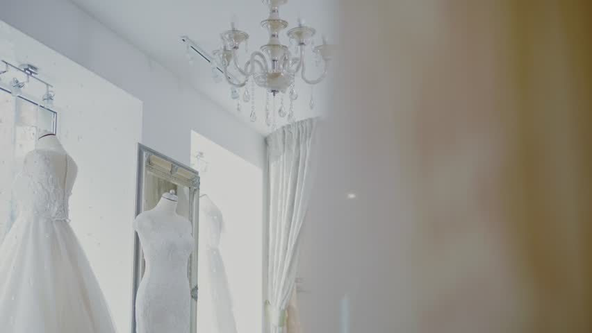Beautifu bride choosing wedding dress in a wedding salon