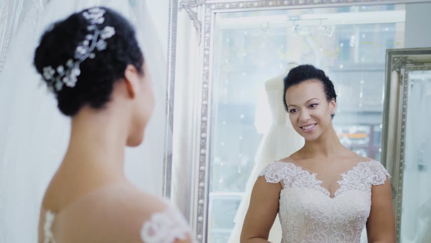 Beautifu bride choosing wedding dress in a wedding salon