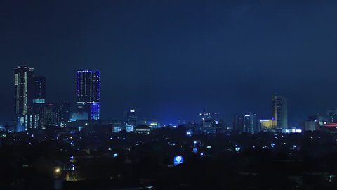 Surabaya, East Java / Indonesia - Jan 16th, 2019: TIMELAPSE Surabaya Downtown Skyline with High-Rise Buildings at Night, Indonesia, Asia