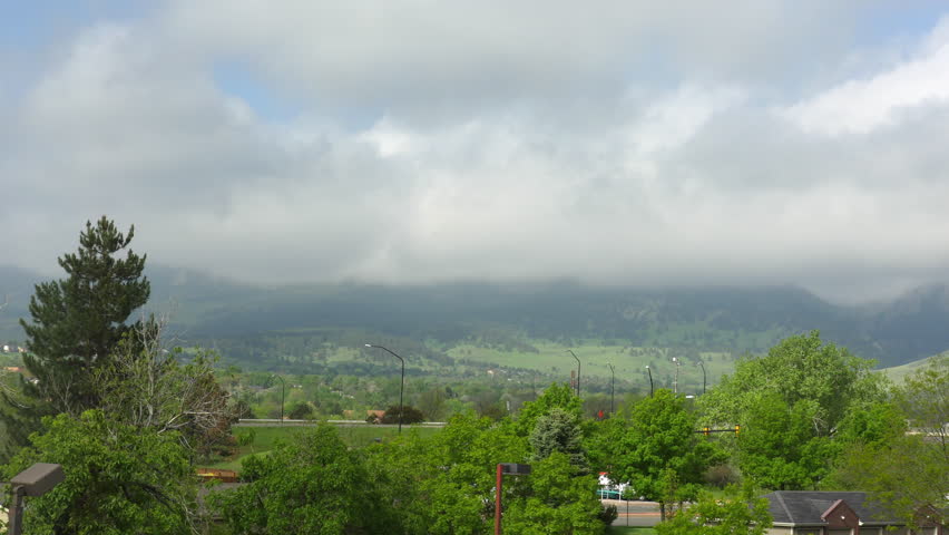 Low clouds obscure the Flatirons mountain range in Boulder Colorado. 4K UHD time-lapse.