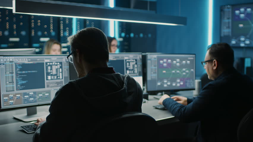 Team of IT Programers Working on Desktop Computers in Data Center Control Room. Young Professionals Writing on Sophisticated Programming Code Language Royalty-Free Stock Footage #1025052575