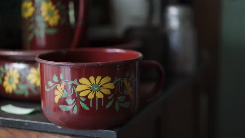 American wild west antique wash bowl and pitcher on an old wooden cabinet.