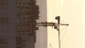 Vertical video. Tower crane against the sky in the afternoon. Ekaterinburg, Russia