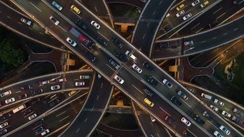 Abstract low angle drone shot of traffic driving over a busy intersection, a convergence of roads in central Shanghai city, China