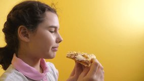 happy little girl eating a slice of pizza concept. teenager child hungry eats a lifestyle slice of pizza. slow motion video. pizza fast food concept