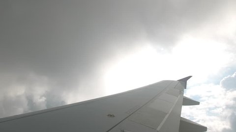 Severe turbulence when flying through thunderstorm clouds. Wing strongly unsteady. The concept of fear of flying on an airplane, the treatment of psychological fear of heights and airplanes. first
