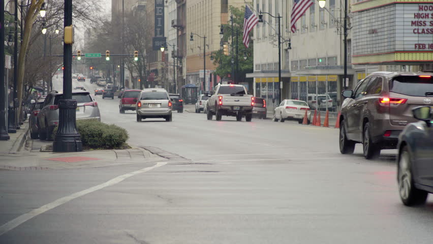 Cars driving in downtown Birmingham, Alabama during a winter rain storm