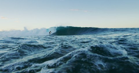 Surfer carves epic turn on wave at sunset, summer adventure lifestyle 