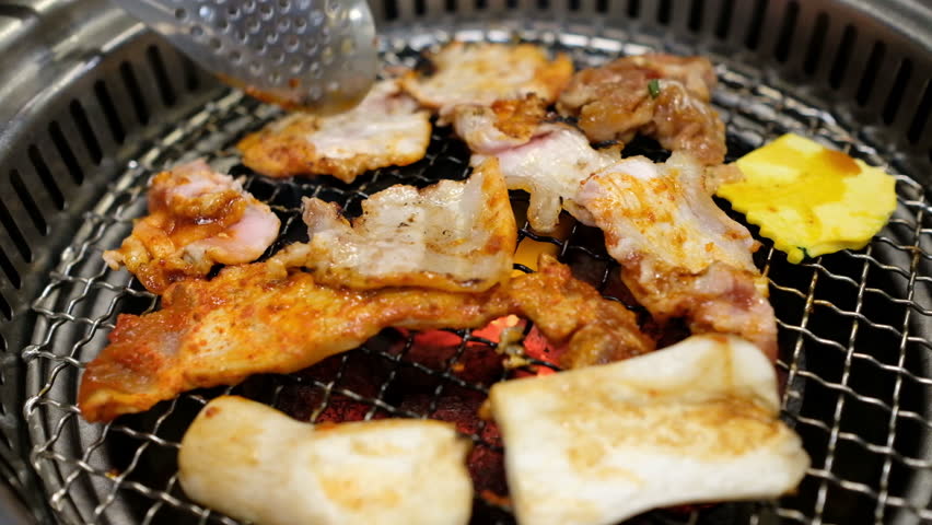 Korean barbecue, raw meat with spicy sauce grilled on the stove.