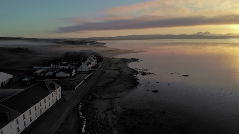 Aerial shot on the Iles of Islay, a Whisky region located in the Hebrides, Scotland, UK. This one shows the coastline road next to Bruichladdich Distillery.